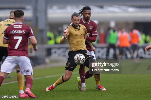 Wrexham's Jay Rodriguez is challenged by Northampton Town's Akinwale Odimayo during the first half of the Sky Bet League 1 match between Northampton...