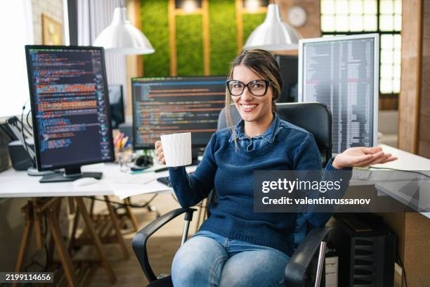female freelance developer coding and programming. coding on two with screens with code language and application - python code stock pictures, royalty-free photos & images