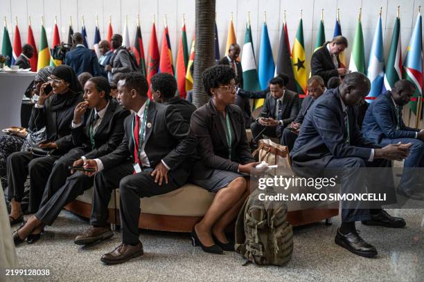 Delegates await outside during a closed session of the 38th African Union Summit at the AU Headquarters in Addis Ababa on February 15, 2025.