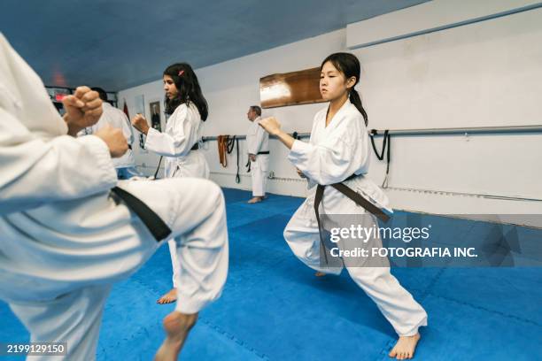 young karate fighters in karate school - kids self defense stock pictures, royalty-free photos & images