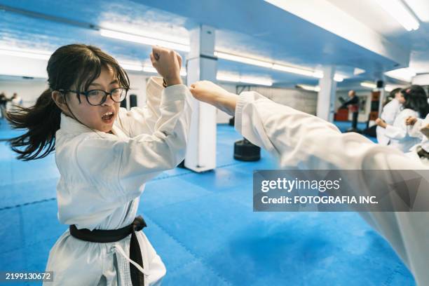 young karate fighters in karate school - karate belt stock pictures, royalty-free photos & images