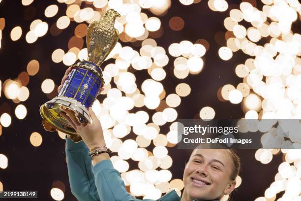Doha, Qatar Amanda Anisimova of the United States holds the trophy after winning against Jelena Ostapenko of Latvia during the Qatar TotalEnergies...