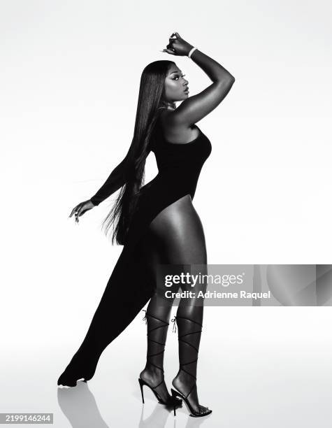 Rapper Megan Thee Stallion wearing a black Rick Owens dress with Femme LA shoes, a Jacob & Co. Necklace and ring, and a David Yurman bracelet and...