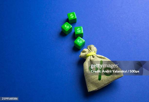 money bag with interest and blocks with dollar symbols concept of deposits and loans earn on deposits dividends - interest rate stock pictures, royalty-free photos & images