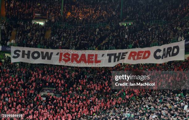 Fans of Celtic hold up a banner reading SHOW ISRAEL THE RED CARD in solidarity with Palestine during the UEFA Champions League 2024/25 League...