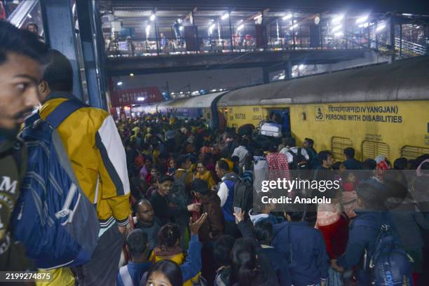 Passengers jostle with each other to board a train at the New Delhi Railway station, in New Delhi, India on February 16, 2025. At least 18 people...