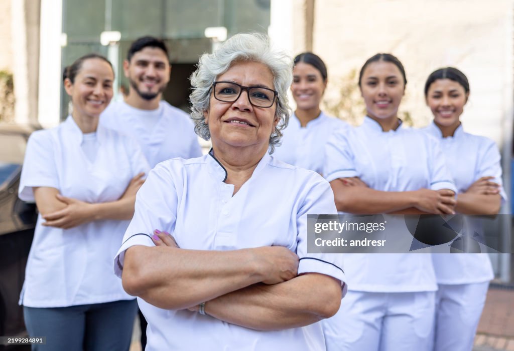 Woman leading a group of employees at an industrial laundry