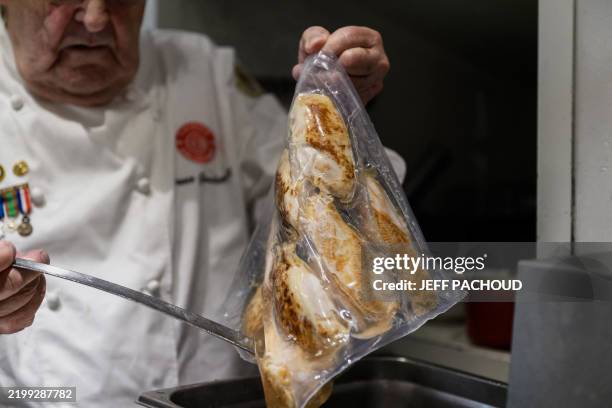 French inventor Bruno Goussault cooks in low-temperature and long-time cooking, using the sous-vide vacume-sealed method in Lyon, central-eastern...