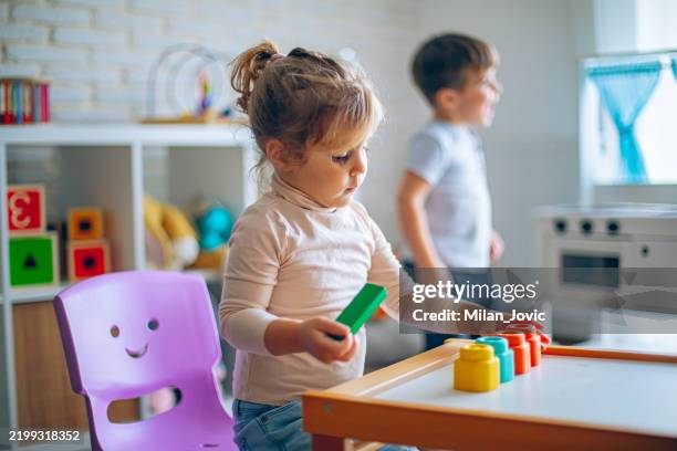 little kids playing with toys in their room, making lunch from toys - preparing food stock pictures, royalty-free photos & images