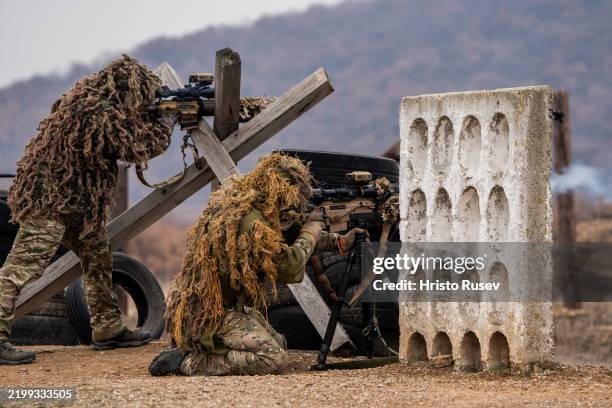 Members of the Spain and Bulgaria sniperists armed forces take part during the NATO exercise Steadfast Dart on February 13, 2025 in Tsrancha,...