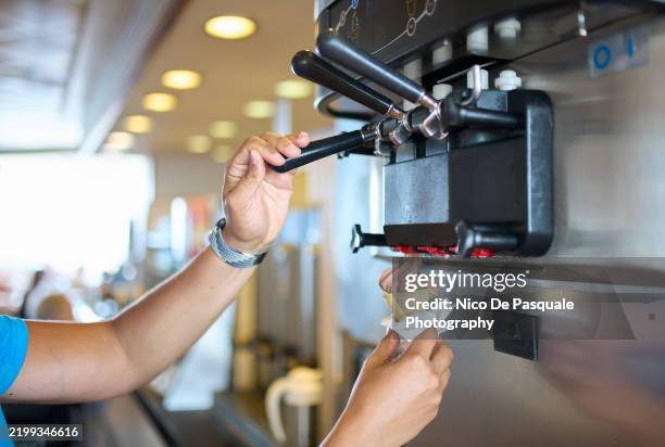 man dispensing soft serve ice cream on cruise ship - mr whippy ice cream stock pictures, royalty-free photos & images