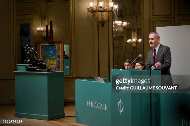 Auctioneer Matthieu Semont proceeds to the auction of French sculptor Camille Claudel's famous bronze sculpture "L'Age mur" in Orleans on February...