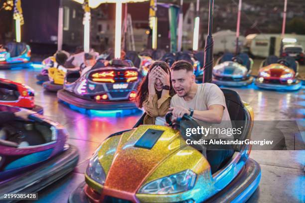 joyful female hiding eyes looking tense after escaping bumper car collision last moment - collision avoidance stock pictures, royalty-free photos & images