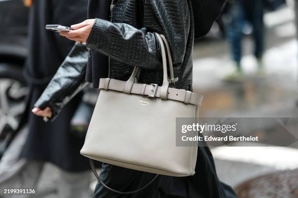 Guest wears a light gray Prada leather bag, outside Sandy Liang, during the New York Fashion week Fall/Winter 2025 on February 9, 2025 in New York,...
