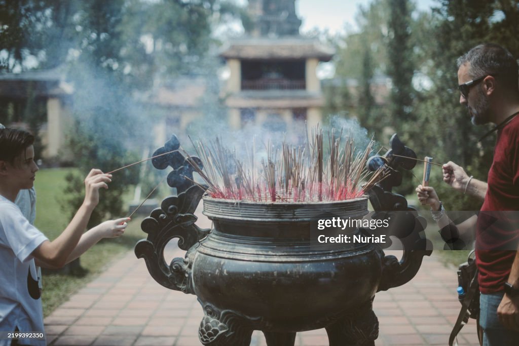 Man and boy praying at temple, Thien Mu Pagoda, Thua Thien Hue, Vietnam