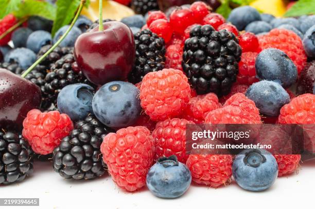 healthy fruits, raspberries, strawberries, cherries, blackberries, blueberries, lemon, mint - cherry stock pictures, royalty-free photos & images