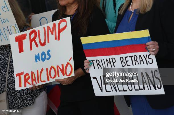 People stand together to support a resolution in favor of reinstating temporary protected status for Venezuelans on February 13, 2025 in Miami,...