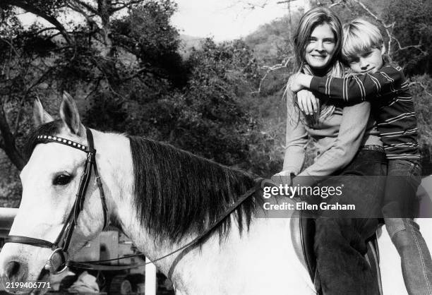 Portrait of American actor Candice Bergen and her brother , Kris Bergen, as they sit together on a horse , Beverly Hills, California, 1971.