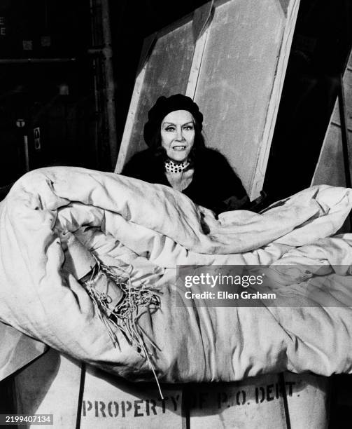 Portrait of American actor Gloria Swanson as she poses behind a large, folded canvas at the Astoria Studio, New York, New York, 1975. The Astoria...