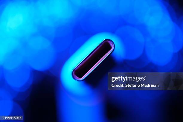 usb c connecter cable with electric blue background - usb cable stock pictures, royalty-free photos & images