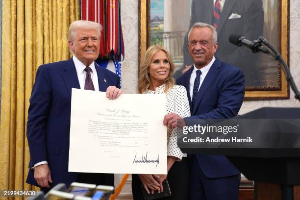 President Donald Trump, Robert F. Kennedy Jr., and Kennedy's wife Cheryl Hines pose after Kennedy was sworn in as Secretary of Health and Human...