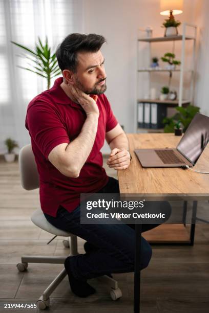 man working from home suffering from neck pain - bad posture stock pictures, royalty-free photos & images