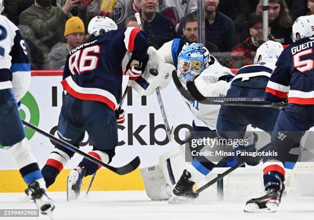 Juuse Saros of Team Finland makes the first period blocker save as Jack Hughes of Team USA skates by in the NHL 4 Nations Face-Off at Bell Centre on...