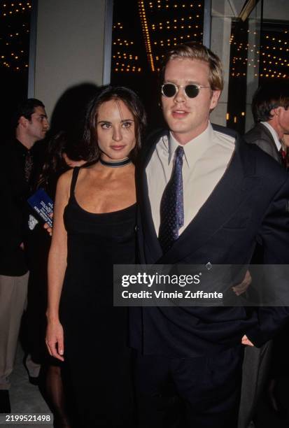 American actress and photographer Lisa Marie Kurbikoff, wearing a sleeveless black scooped-neck dress with a black-and-grey choker, and her partner,...