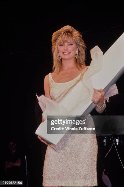 American fashion model Kelly Emberg, wearing a white scoop-neck dress, at the inaugural Fashion & Models Ball, in New York, 24th February 1984....