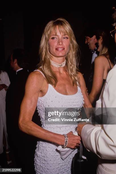 American model Kelly Emberg, wearing a white scooped neck outfit with a multi-strand pearl choker, attends the 7th Annual American Society of...