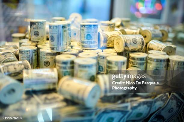stacks of rolled us dollar bills - welvaart stockfoto's en -beelden