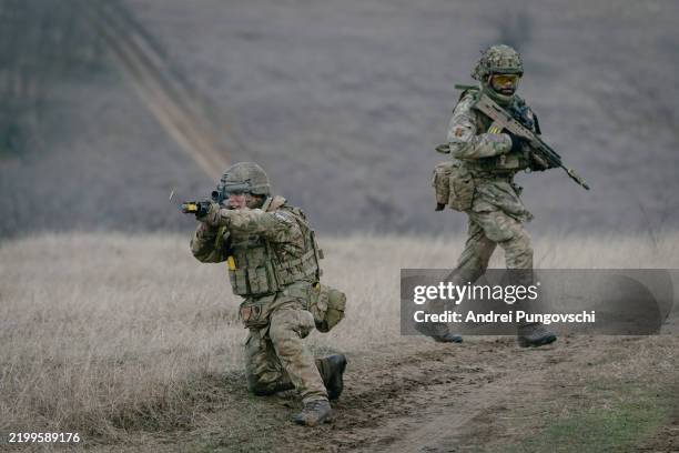 British soldiers practice retreat under fire during an exercise on February 17, 2025 in Smardan, Romania. The UK's 1st Division is commanding land...