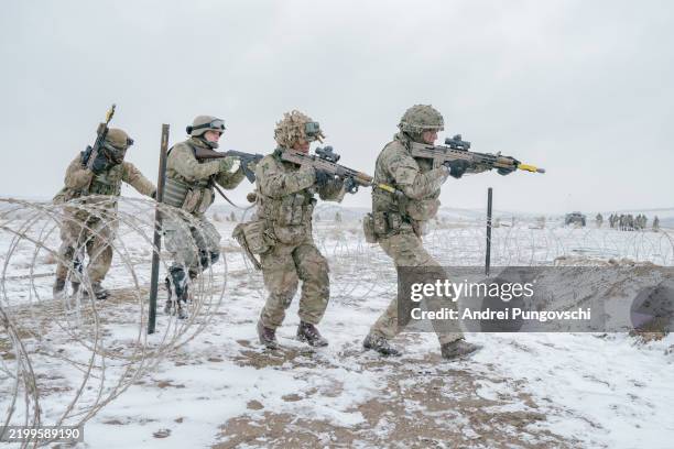 British soldiers practice an assault on February 17, 2025 in Smardan, Romania. The UK's 1st Division is commanding land forces during Exercise...