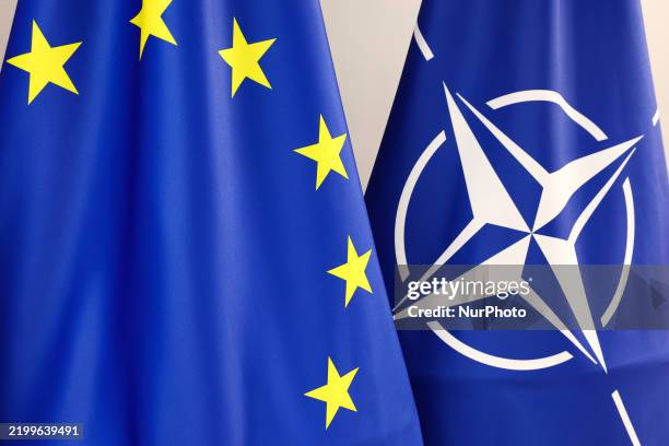 Flags of European Union and NATO are seen before the cooperation agreement signing ceremony between Polish Ministry of National Defense And Microsoft...