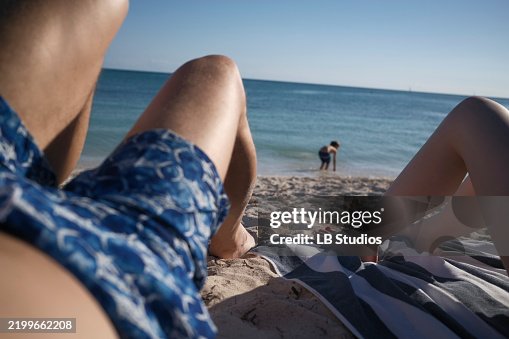 Relaxing on a sandy beach with a view of the ocean and people enjoying the sunny day, Florida Keys, USA Relaxing on a sandy beach with a view of the ocean and people enjoying the sunny day, Florida Keys, USA