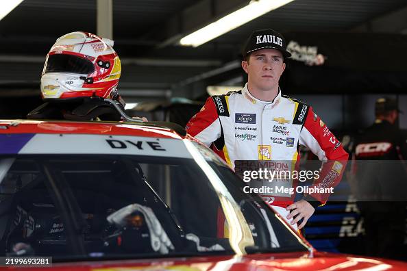 Daniel Dye, driver of the Champion Container Chevrolet looks on in ...