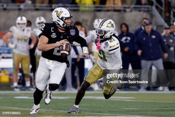Vanderbilt Commodores quarterback Diego Pavia scrambles from Georgia Tech Yellow Jackets defensive back Omar Daniels during the Birmingham Bowl...