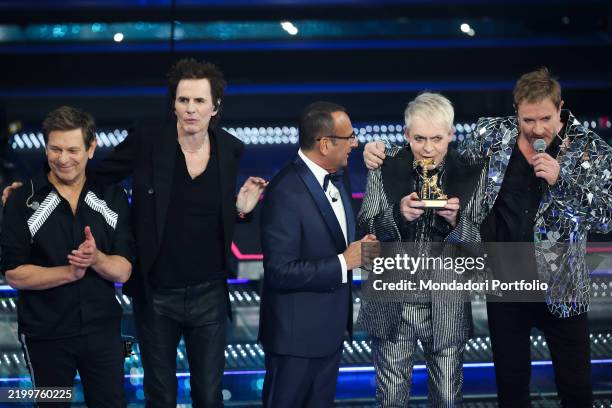 Roger Taylor, John Taylor, Nick Rhodes, Simon Le Bon of British musical group Duran Duran with Italian presenter Carlo Conti at 75 Sanremo Music...