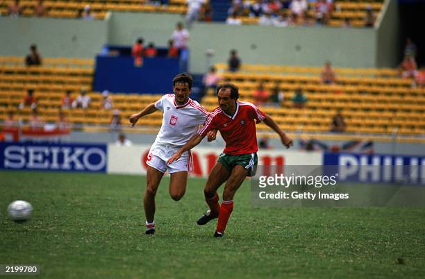 Jaime Pacheco of Portugal crosses the ball as Roman Wojcicki of Poland closes in during the FIFA World Cup Finals 1986 Group F match between Poland...