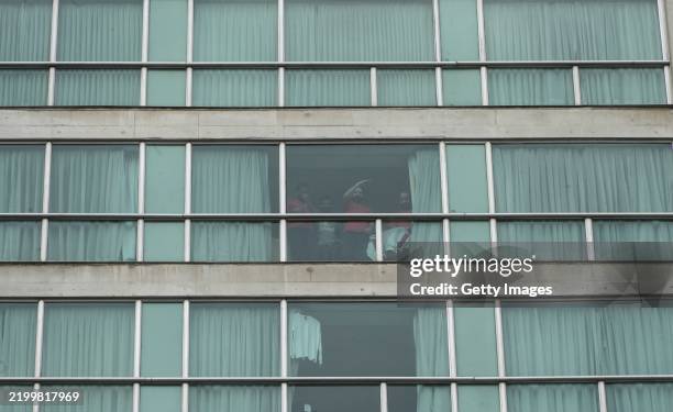 Migrants deported by the US look out the windows at the Decapolis Hotel in Panama on February 18, 2025 in Panama City, Panama. Hundreds of deportees...