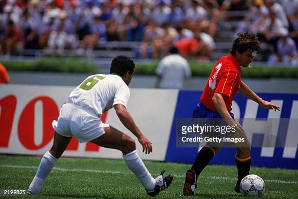 Jose Antonio Camacho of Spain looks to hold the ball up against Said Kaci of Algeria during the FIFA World Cup Finals 1986 Group D match between...