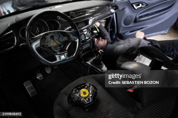 Mechanic removes from a car an airbag module made by the Japanese airbag manufacturer Takata, in a garage in Mulhouse, eastern France, on February...
