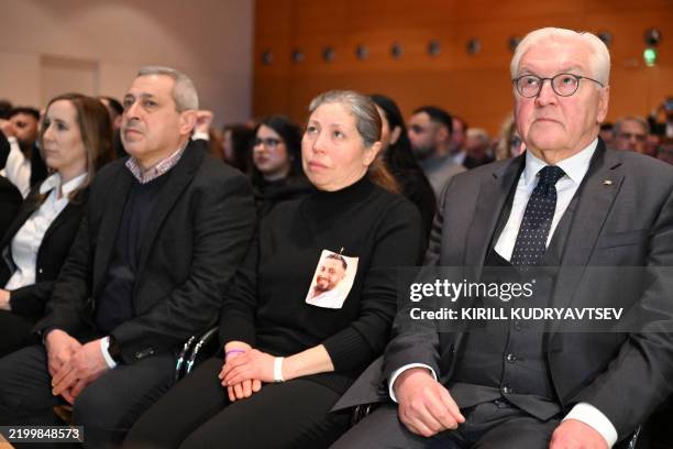 German President Frank-Walter Steinmeier sits among relatives of the victims during the memorial ceremony of the 2020 Hanau attack on February 19,...