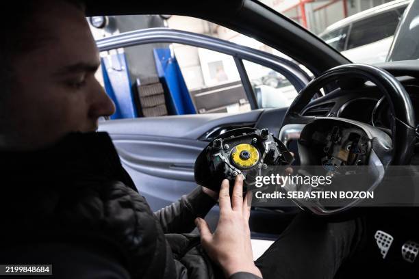 Mechanic removes from a car an airbag module made by the Japanese airbag manufacturer Takata, in a garage in Mulhouse, eastern France, on February...