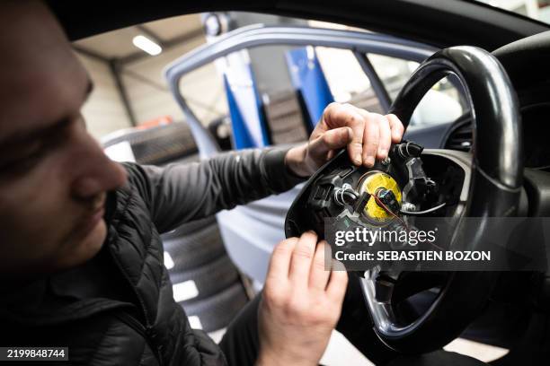 Mechanic removes from a car an airbag module made by the Japanese airbag manufacturer Takata, in a garage in Mulhouse, eastern France, on February...