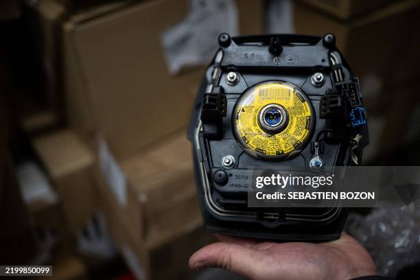 Mechanic holds an airbag module made by the Japanese airbag manufacturer Takata, in a garage in Mulhouse, eastern France, on February 19, 2025. Some...