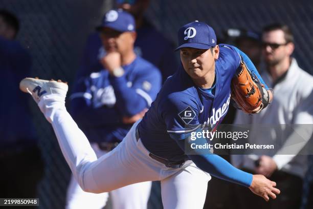 Pitcher Shohei Ohtani of the Los Angeles Dodgers throws in the bullpen during a team workout at Camelback Ranch on February 15, 2025 in Glendale,...