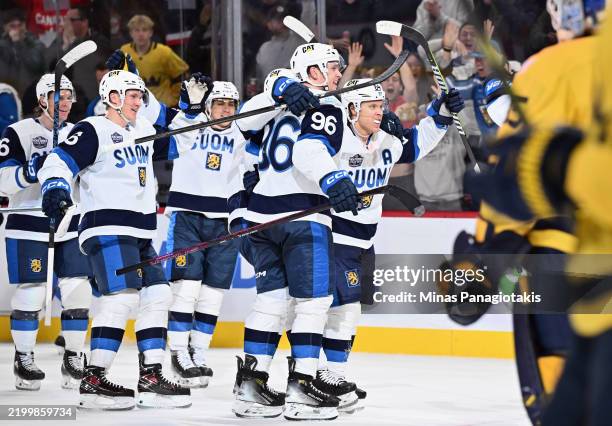 Mikael Granlund of Team Finland celebrates his game-winning overtime goal against Team Sweden and is joined by Mikko Rantanen and the rest of the...