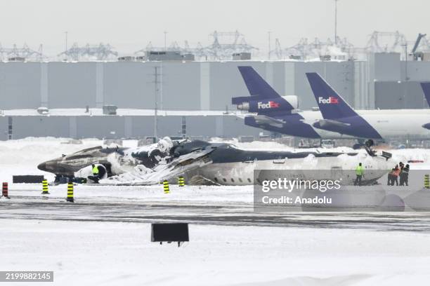 Wreckage of Delta Airlines plane that crashed upon landing at Toronto Pearson Airport is seen on tarmac as the investigation continues two days after...