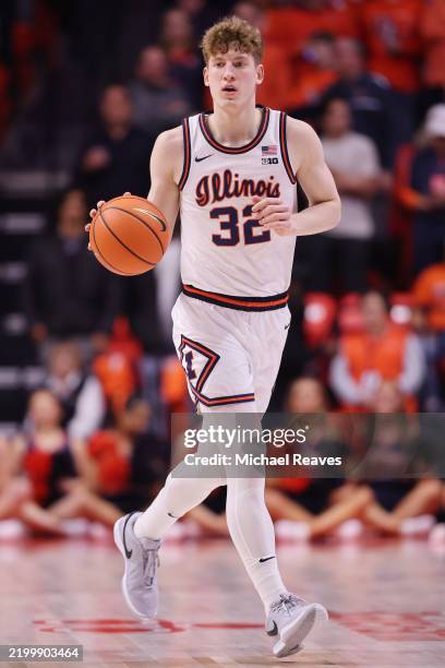 Kasparas Jakucionis of the Illinois Fighting Illini dribbles up the court against the Michigan State Spartans during the first half at State Farm...